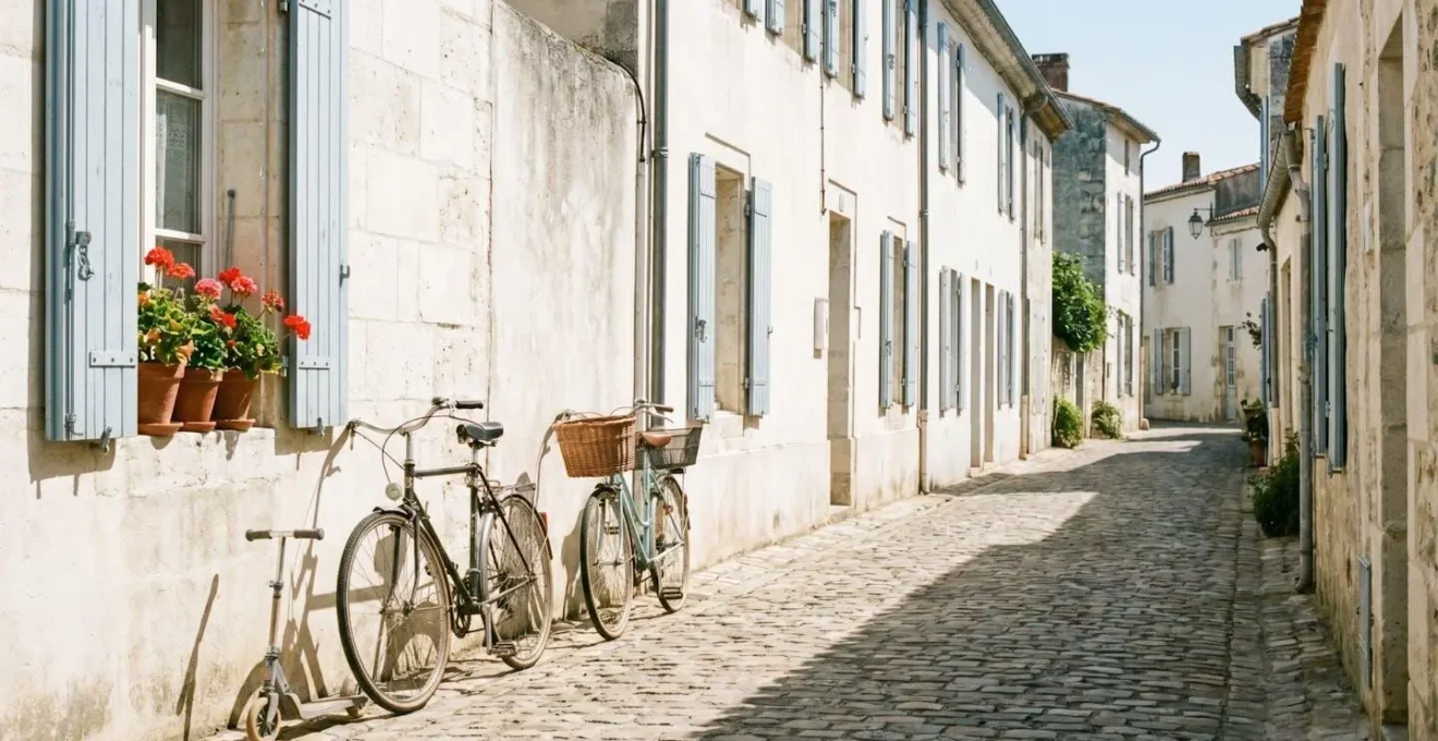 Quiet village street on Île de Ré with bicycles parked outside a white stone house in summer